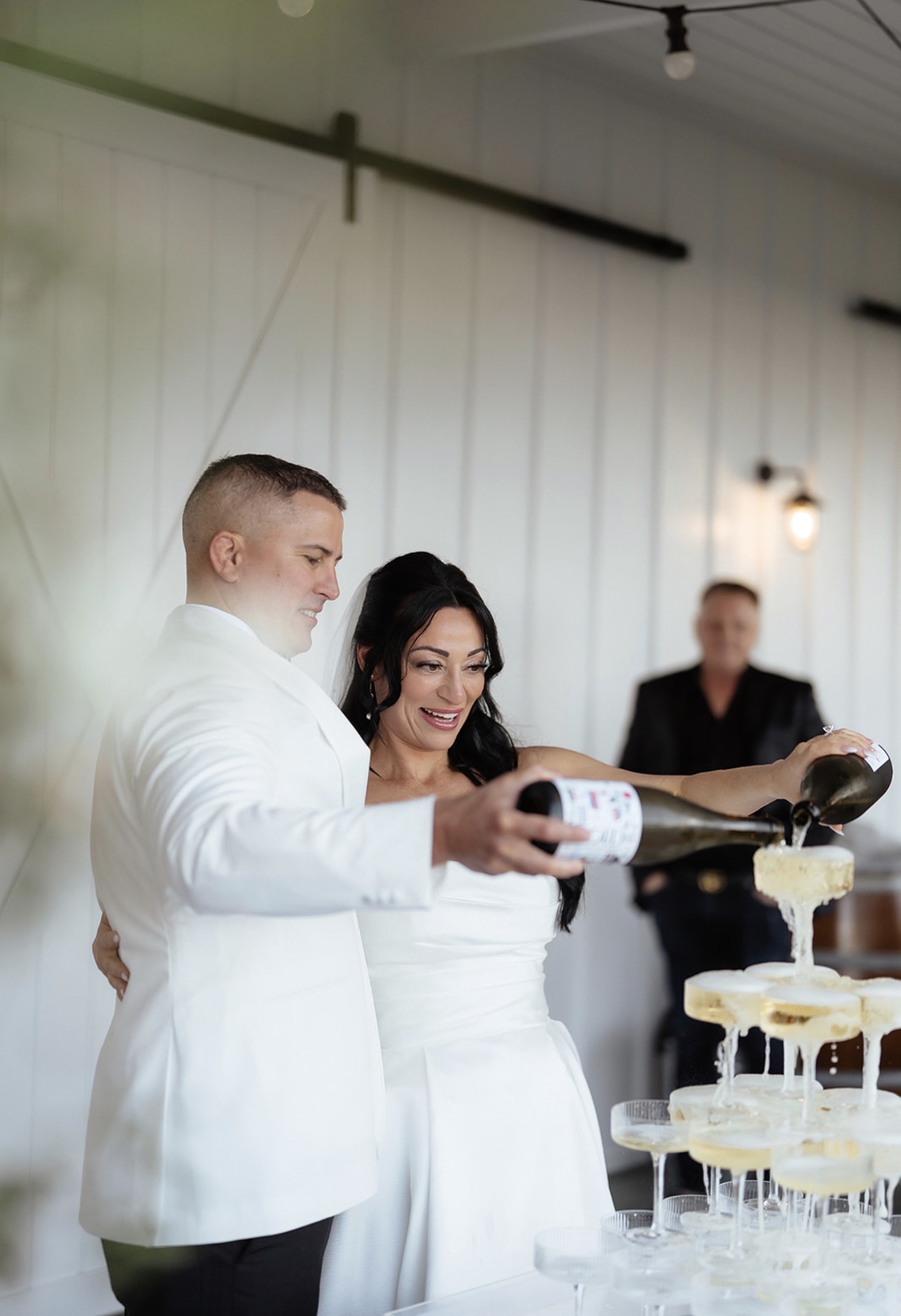 Mel and Cliffe pouring the champagne tower